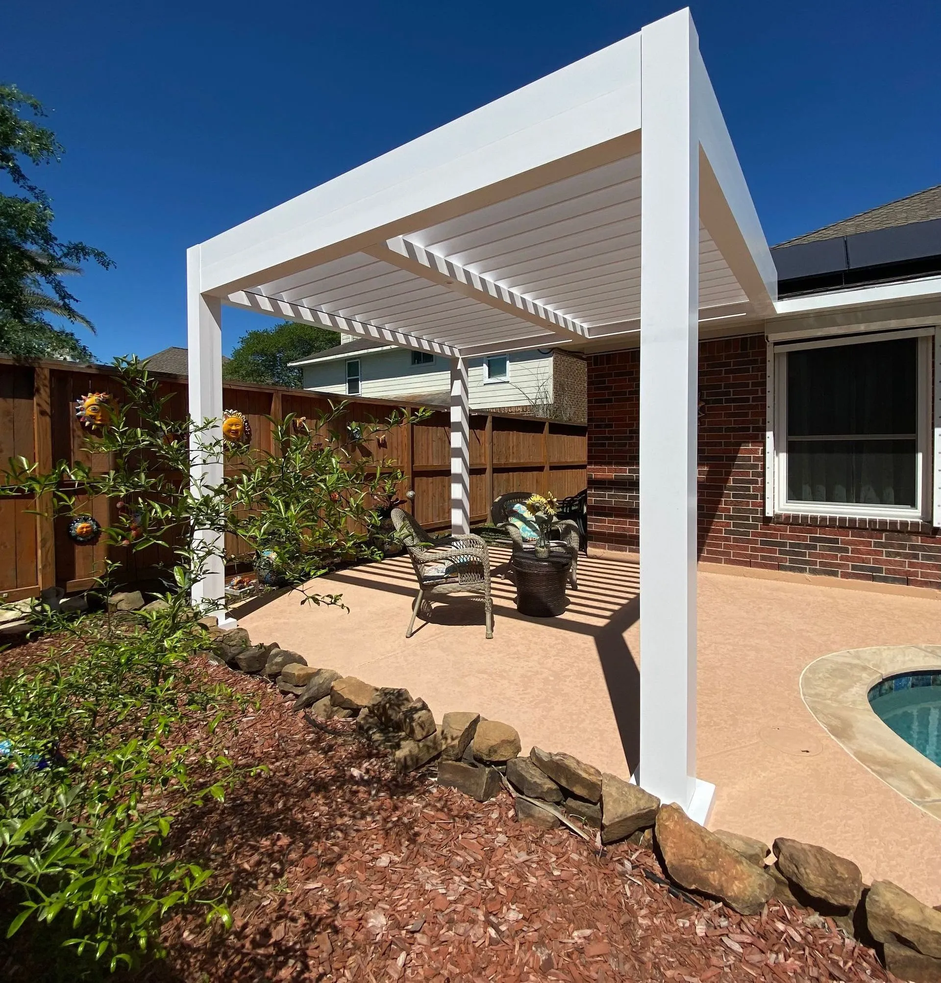 Louvered pergola with adjustable roof installed by Kool Covers
